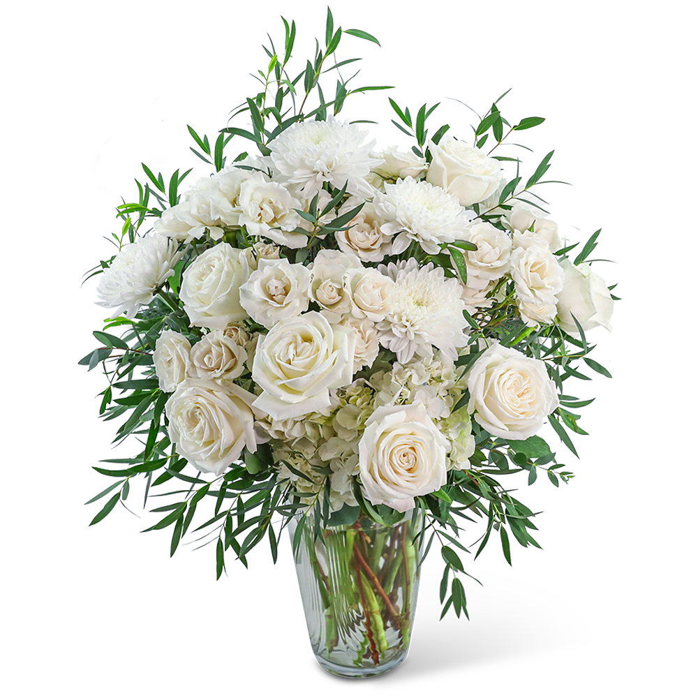 White roses and chrysanthemums in a clear glass vase