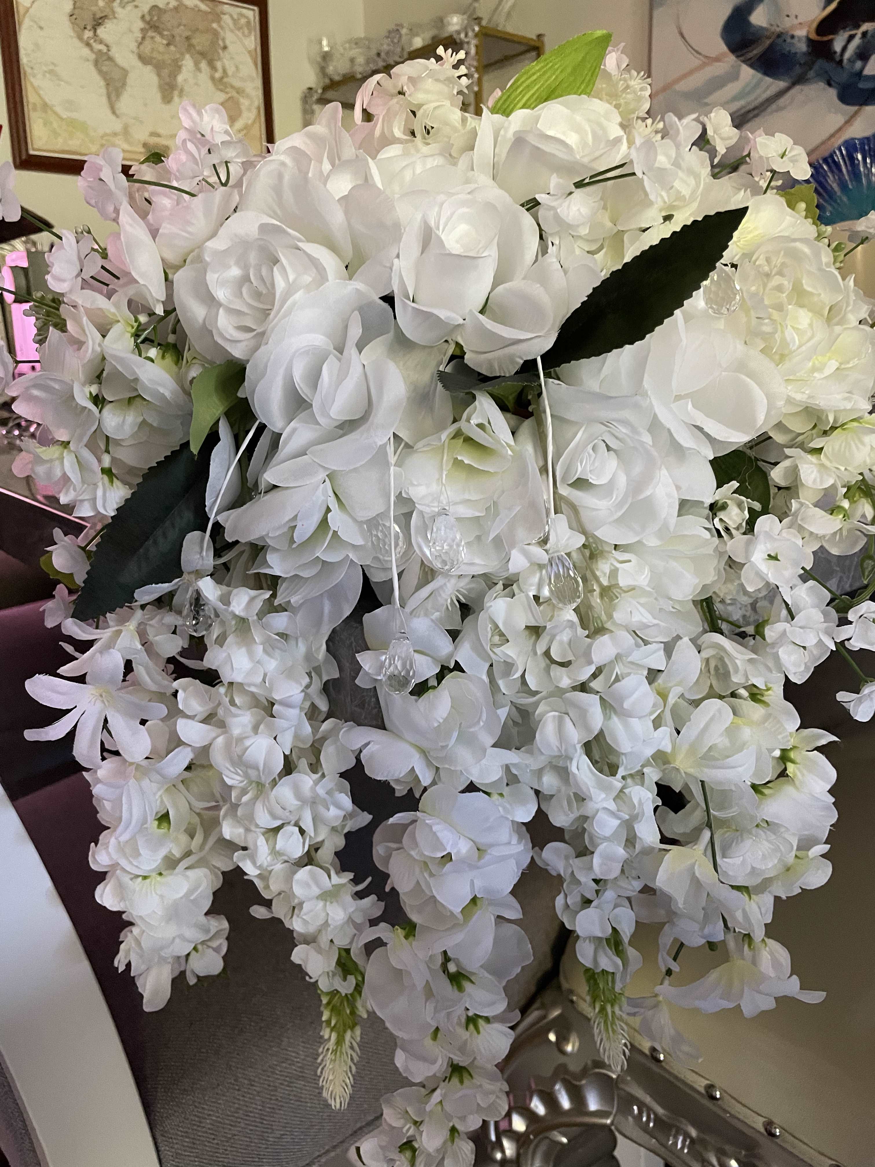 Large white floral arrangement with cascading blooms and pale pink accents