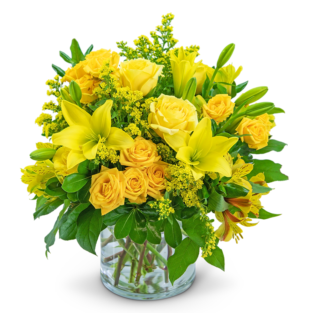 Yellow roses and lilies arranged in a clear glass vase