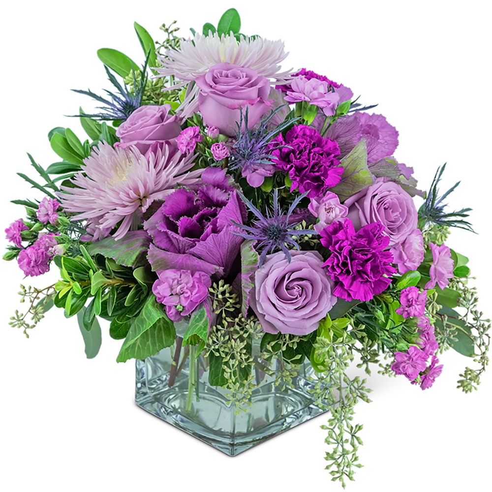 Lavender and purple mixed bouquet in a square glass vase