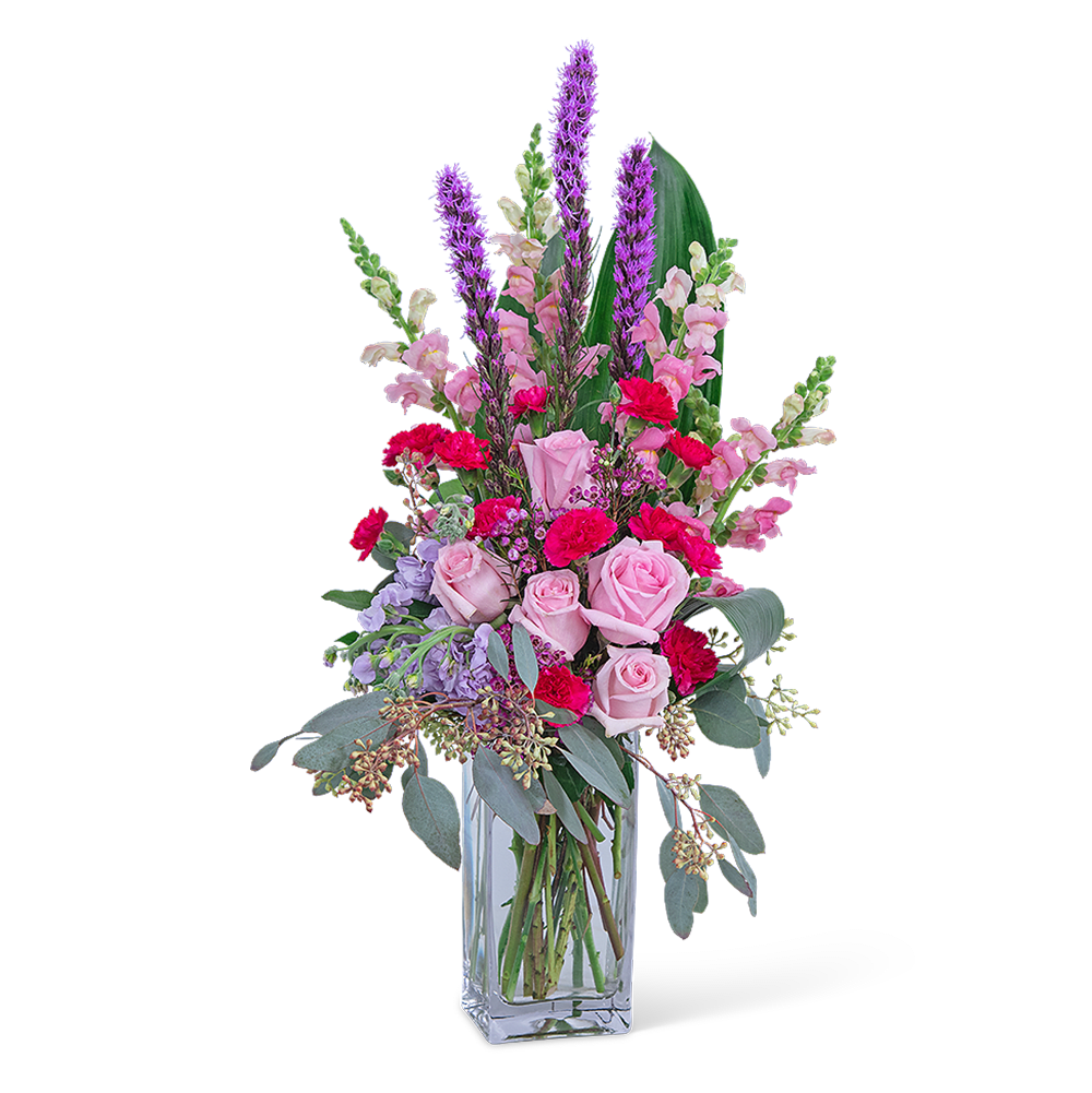 Pink and purple mixed flower arrangement in a clear glass vase