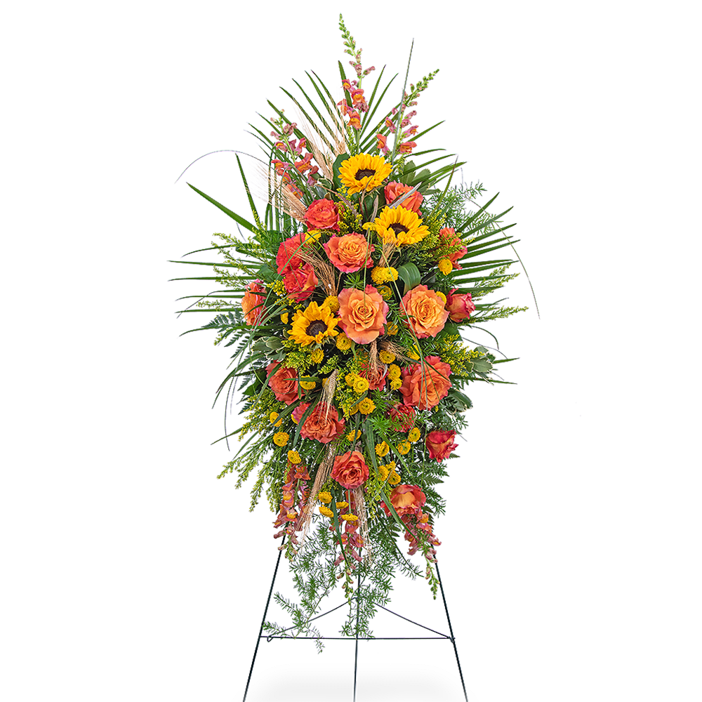 Tall standing spray with orange roses and yellow sunflowers on an easel