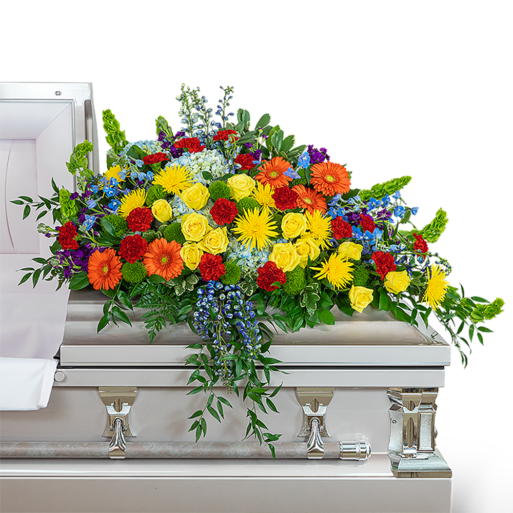 Colorful floral spray on a silver casket