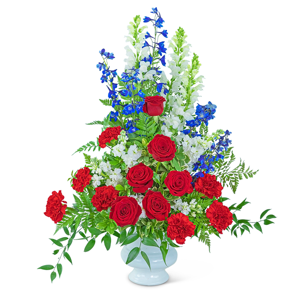 Tall red, white, and blue floral arrangement in a white vase
