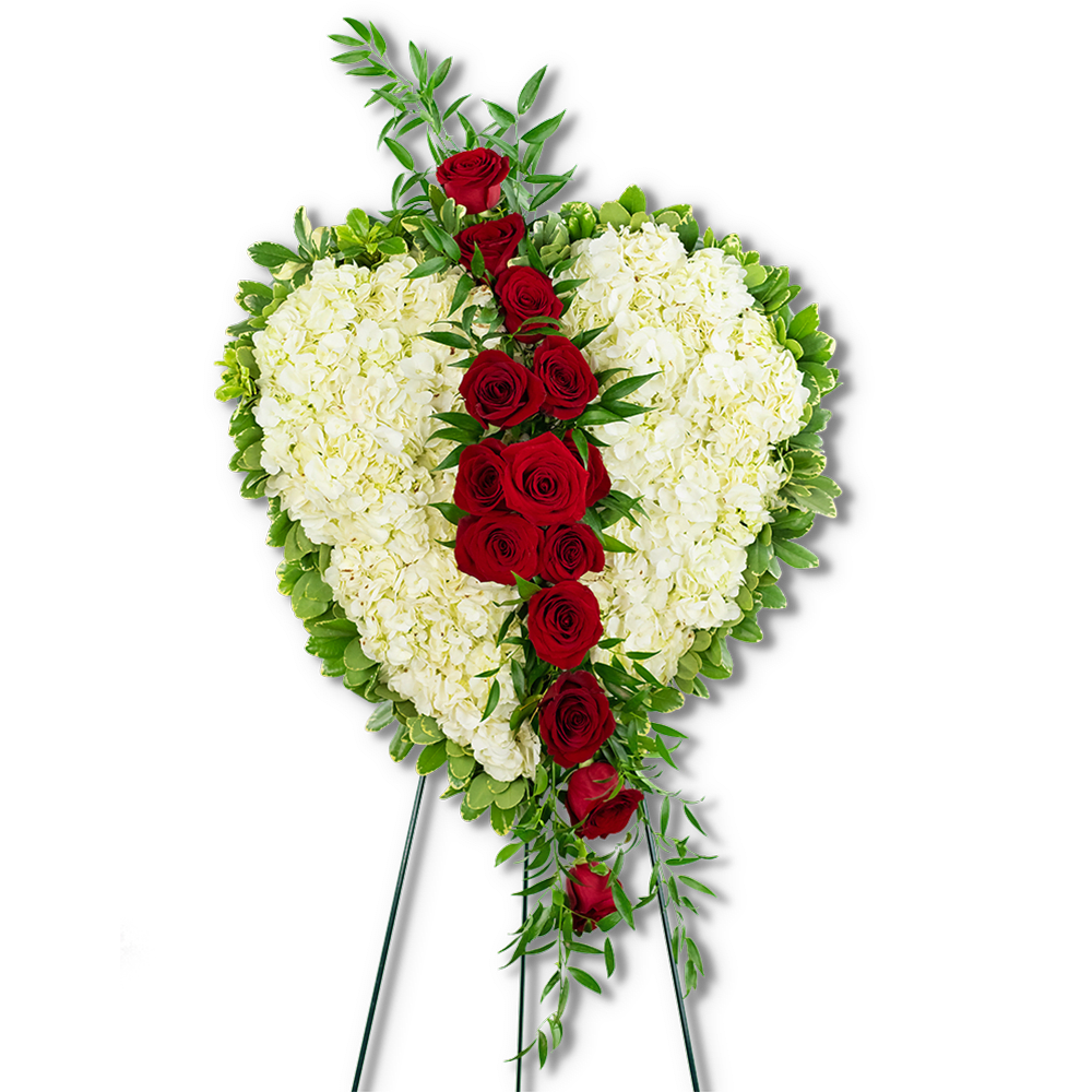 Heart-shaped floral spray with red roses and white hydrangeas on a stand