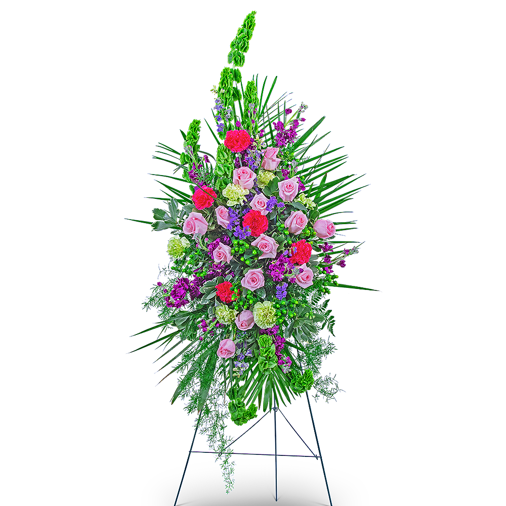 Standing floral spray with pink roses and bright mixed flowers on an easel