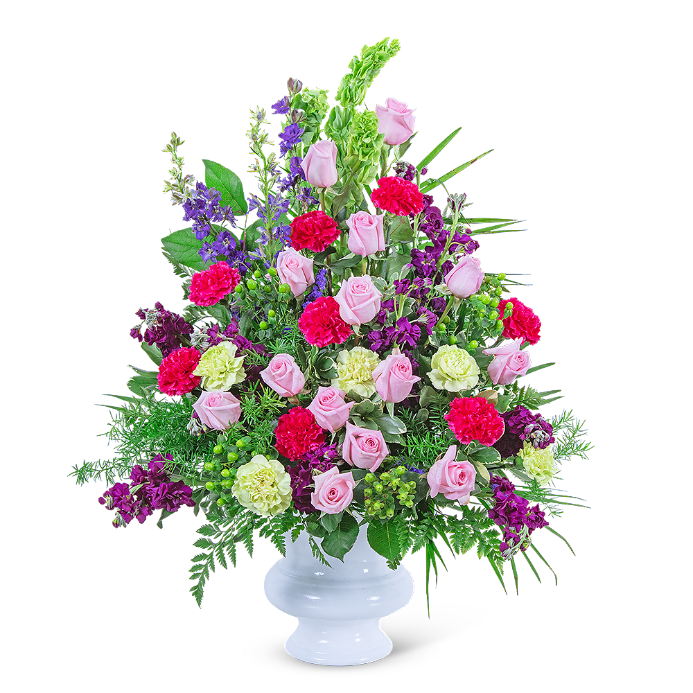 Pink roses and purple flowers in a white pedestal vase