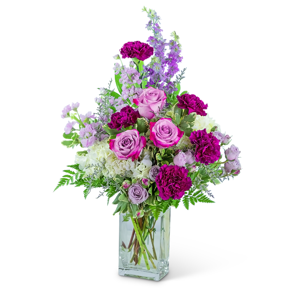 Pink and purple flower arrangement in a clear glass vase