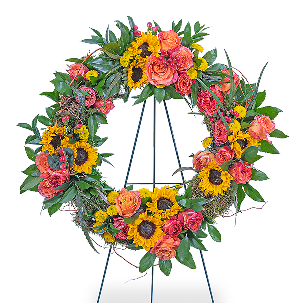 Circular floral wreath with sunflowers, orange roses, and pink blooms