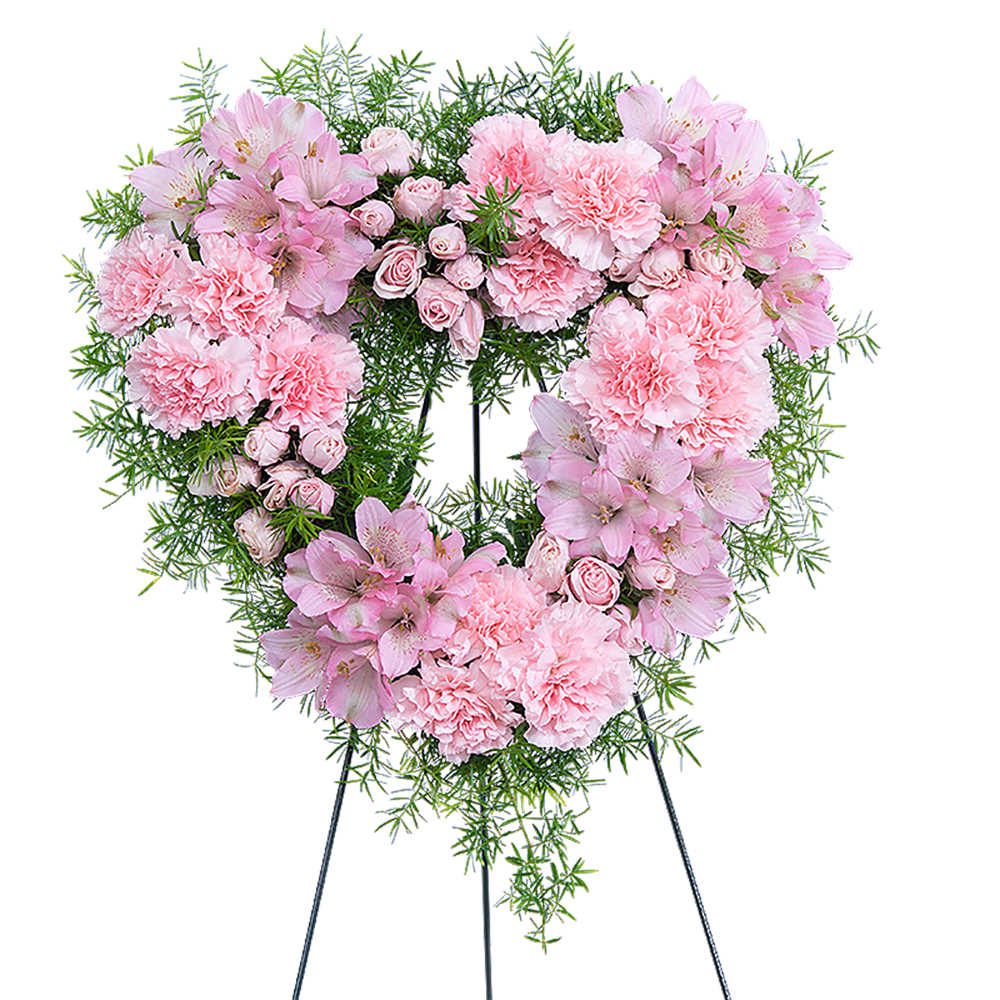 Heart-shaped pink floral wreath on a stand