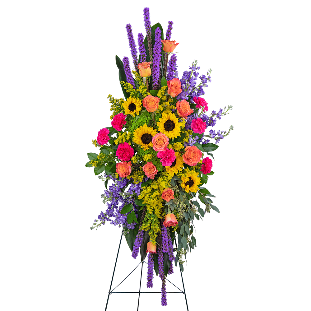 Tall standing floral spray with sunflowers, roses, and purple spikes