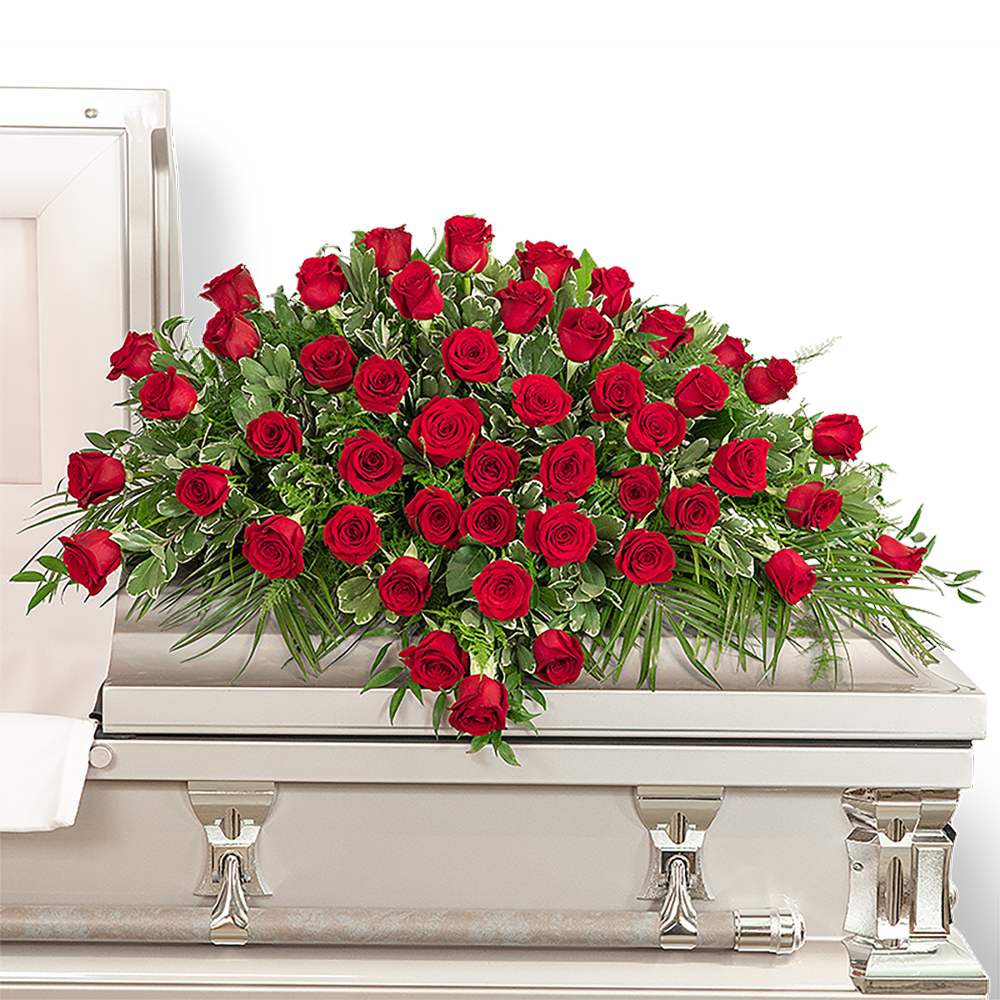 Red rose casket spray on a white casket
