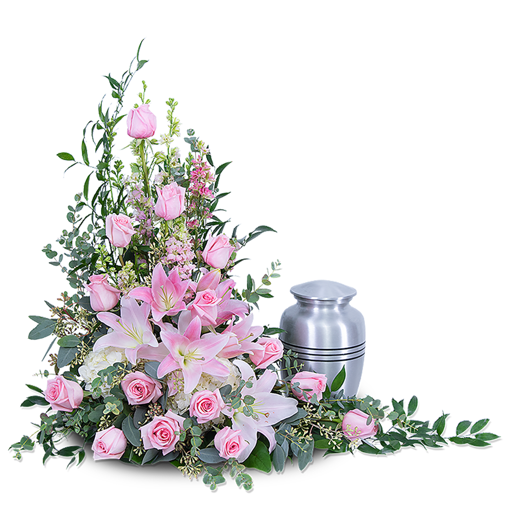 Pink roses and lilies arranged beside a silver urn