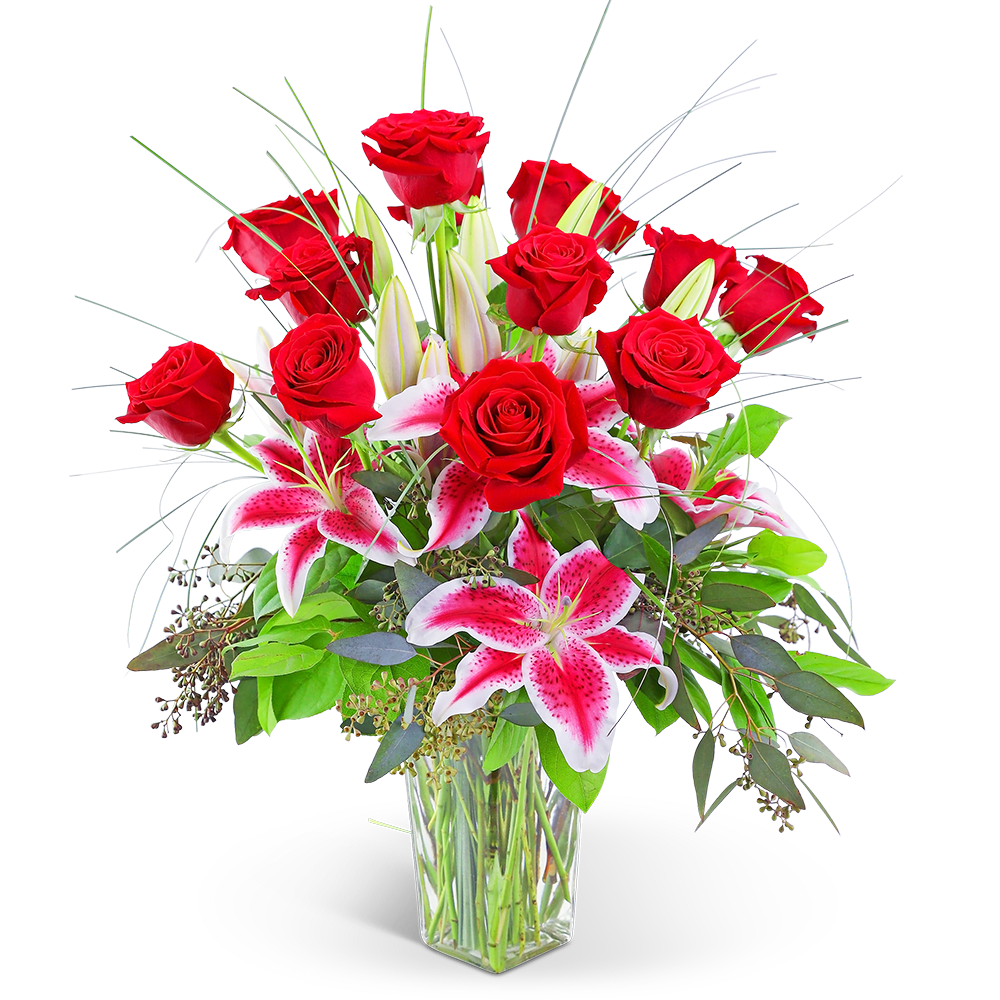 Red roses and pink lilies in a clear glass vase