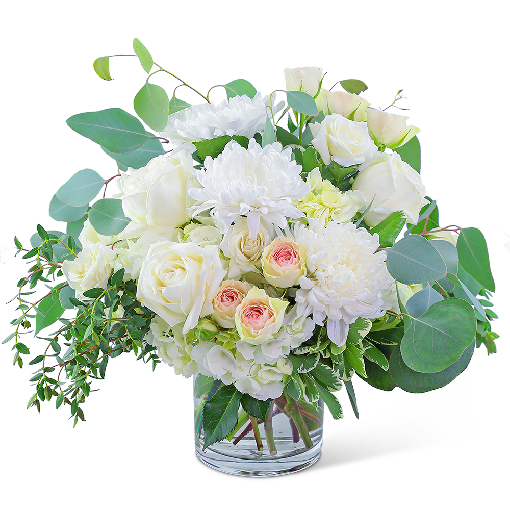 Blush Garden - Awaken the senses as you walk into your own romantic floral fantasy! Traditional roses, contemporary mums, and playful hydrangea mix to create a stunning bouquet! Blush Garden is bursting with blossoms and arranged in an eye-catching clear glass vase, accented with premium foliage. A shop favorite, this timeless beauty is perfect for any occasion!