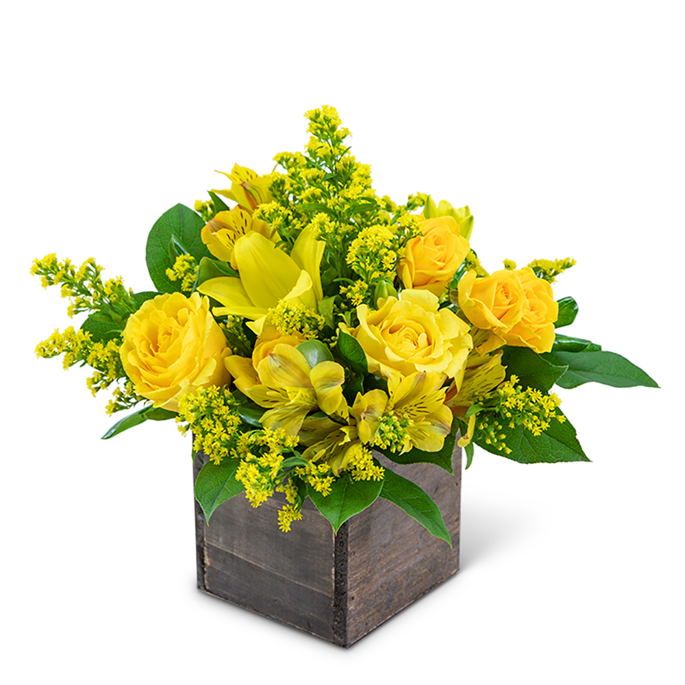 Yellow roses and lilies in a wooden cube container