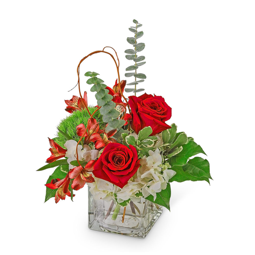 Red roses and white flowers in a square glass vase