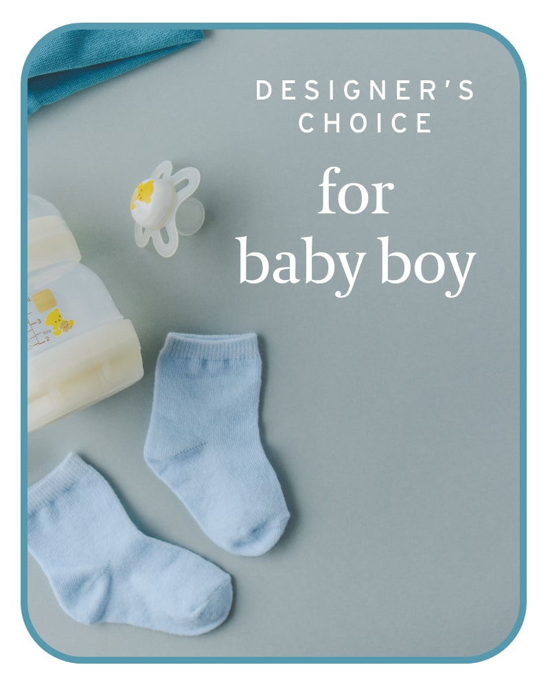Baby socks, pacifier, and bottle on a blue card reading "designer's choice for baby boy"