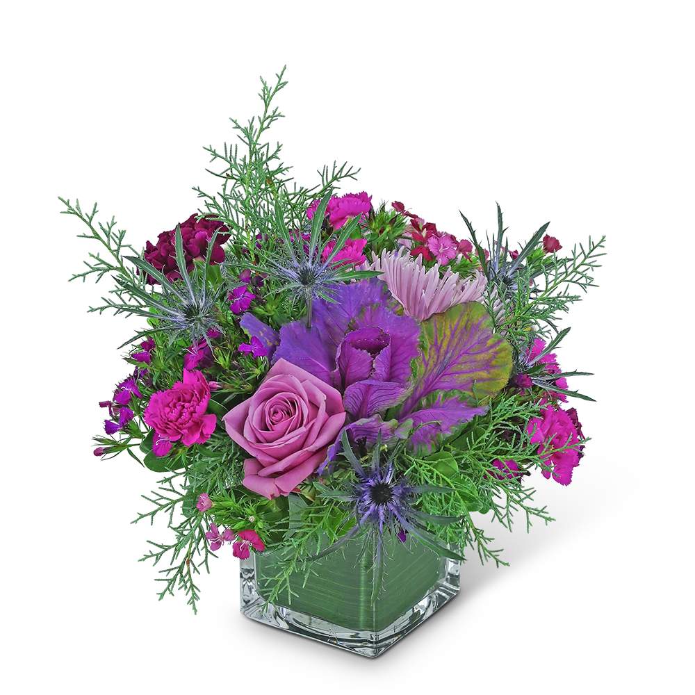Pink and purple floral arrangement in a clear square vase
