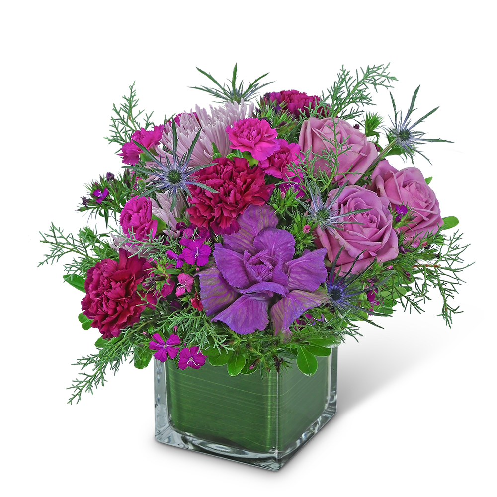 Purple and pink bouquet in a clear square vase
