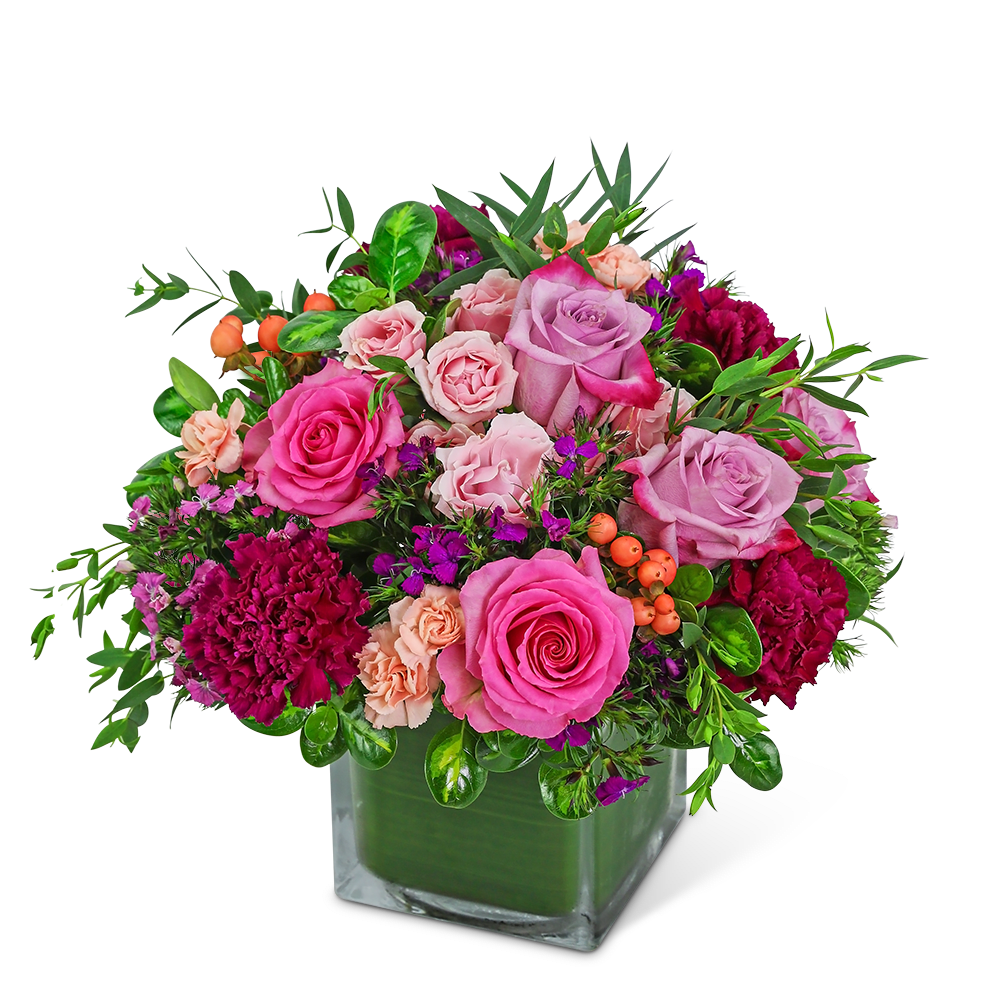 Pink and lavender roses with carnations in a square glass vase