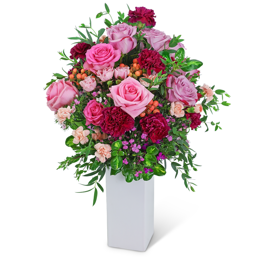 Pink and burgundy floral arrangement in a white vase