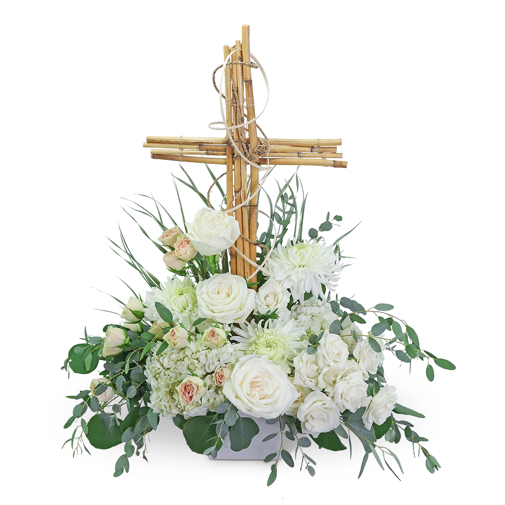 White floral arrangement with a wooden cross centerpiece
