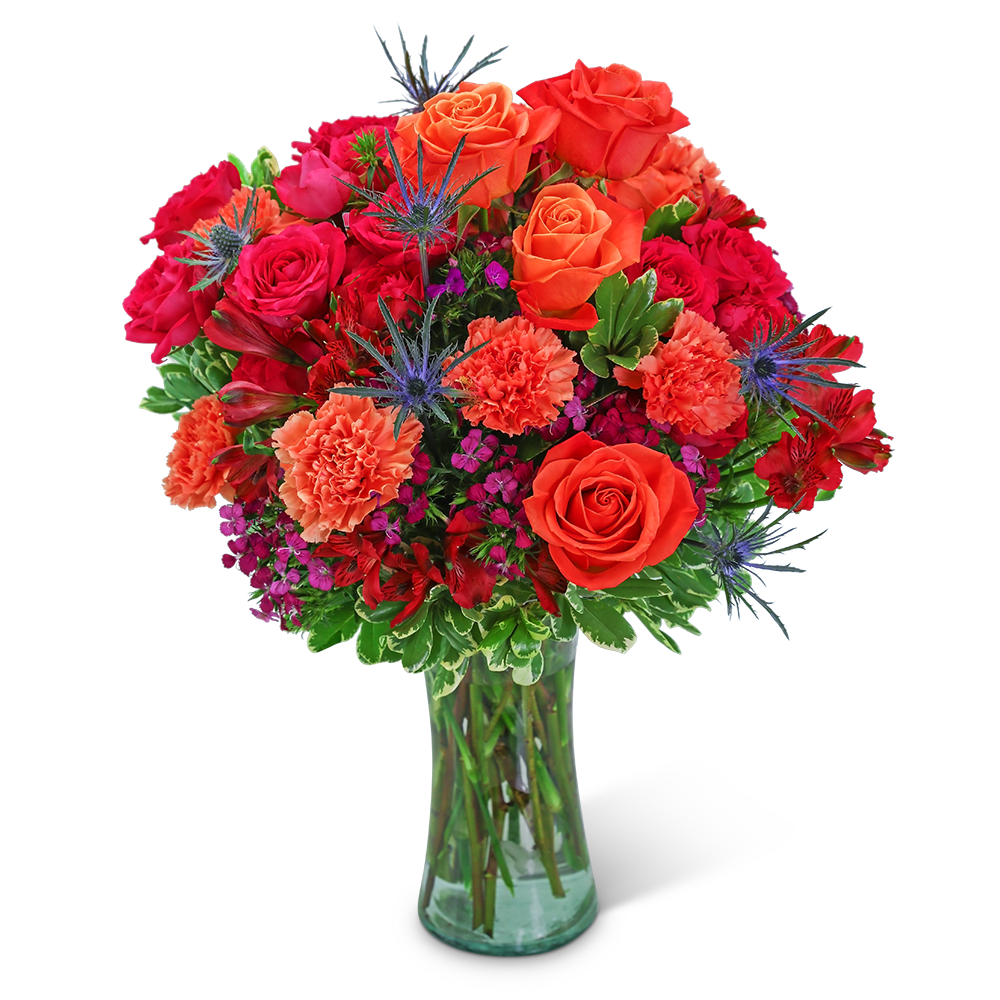 Bouquet of orange and red roses with carnations in a glass vase