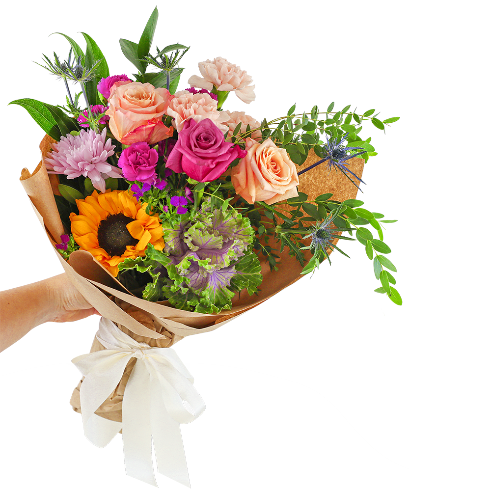 Hand-tied bouquet of mixed roses, carnations, and a sunflower in brown paper