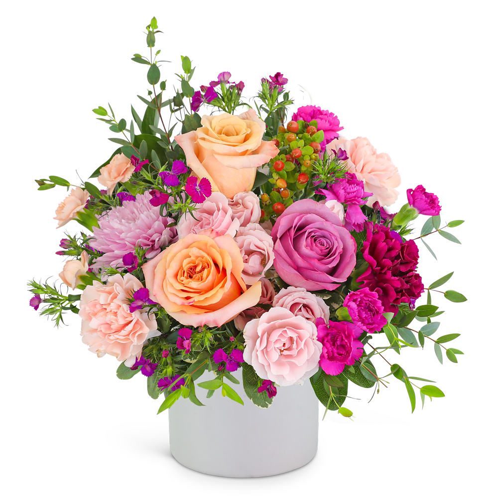 Mixed pink and peach flower arrangement in a white vase