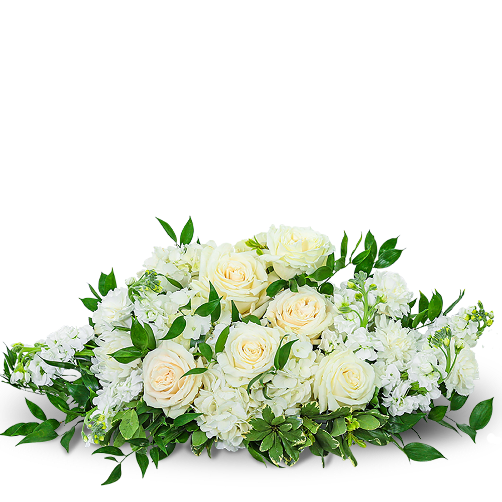 Cream roses and white flowers in a low arrangement with greenery