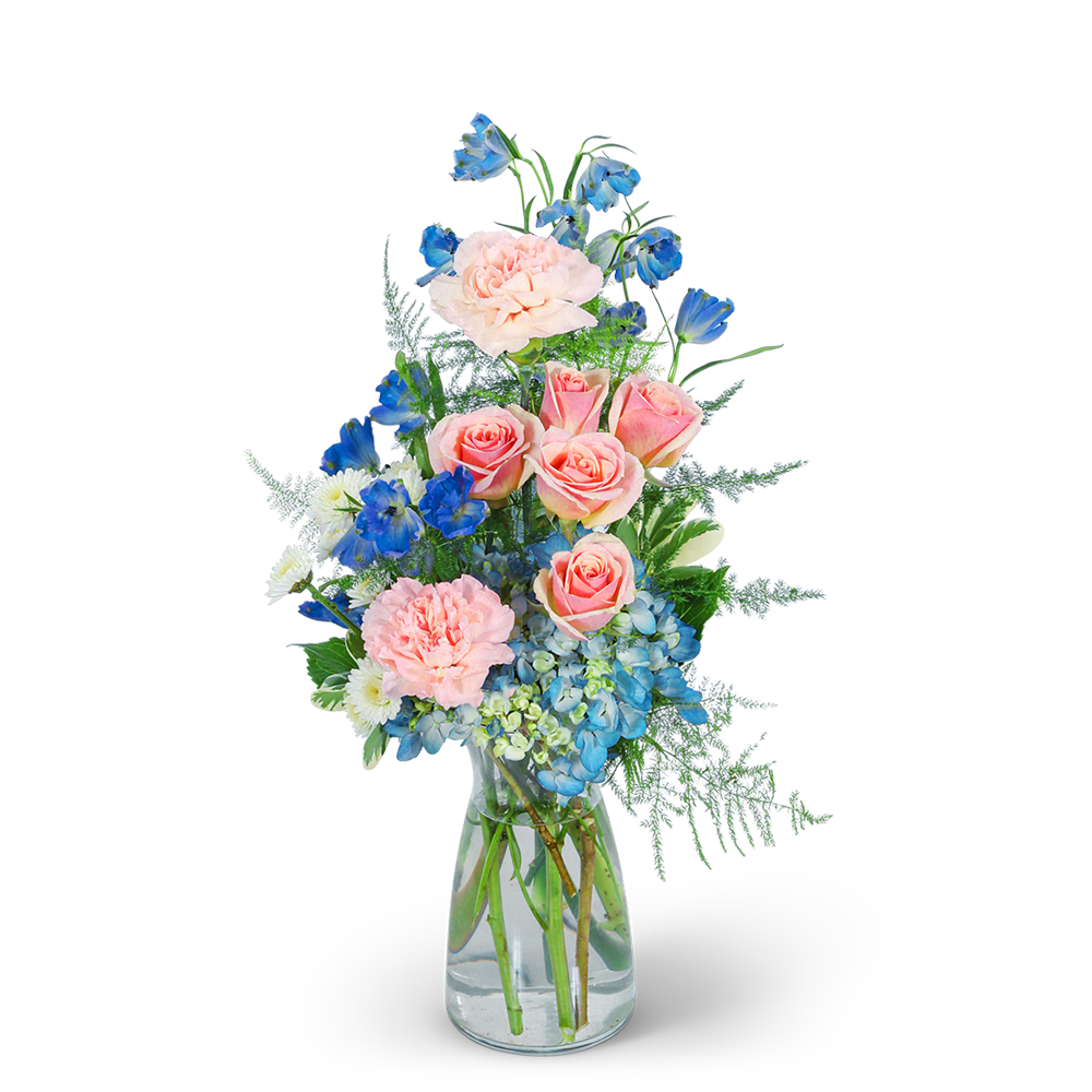 Pink roses and blue flowers arranged in a clear glass vase