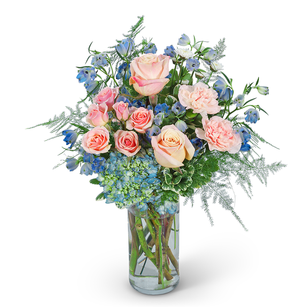 Pink roses and blue flowers in a clear glass vase