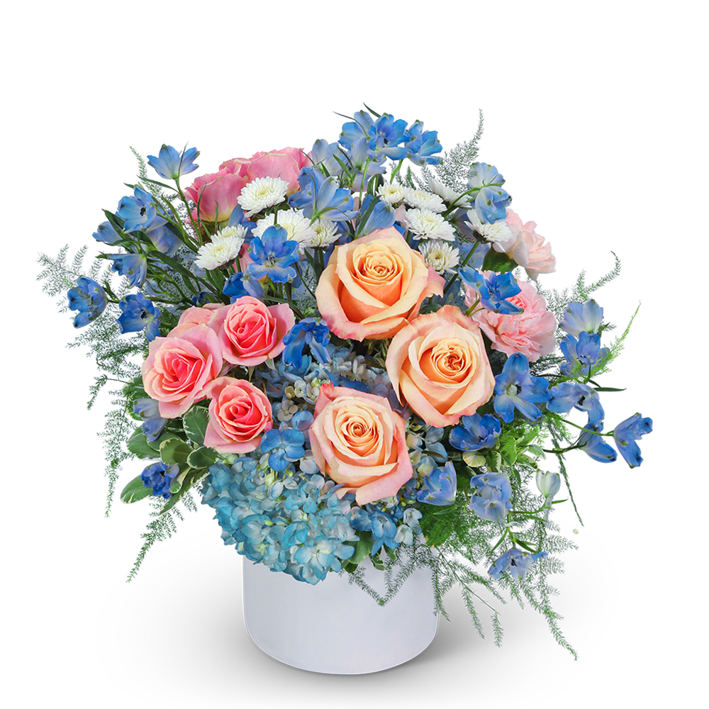 Bouquet of peach and pink roses with blue flowers in a white vase