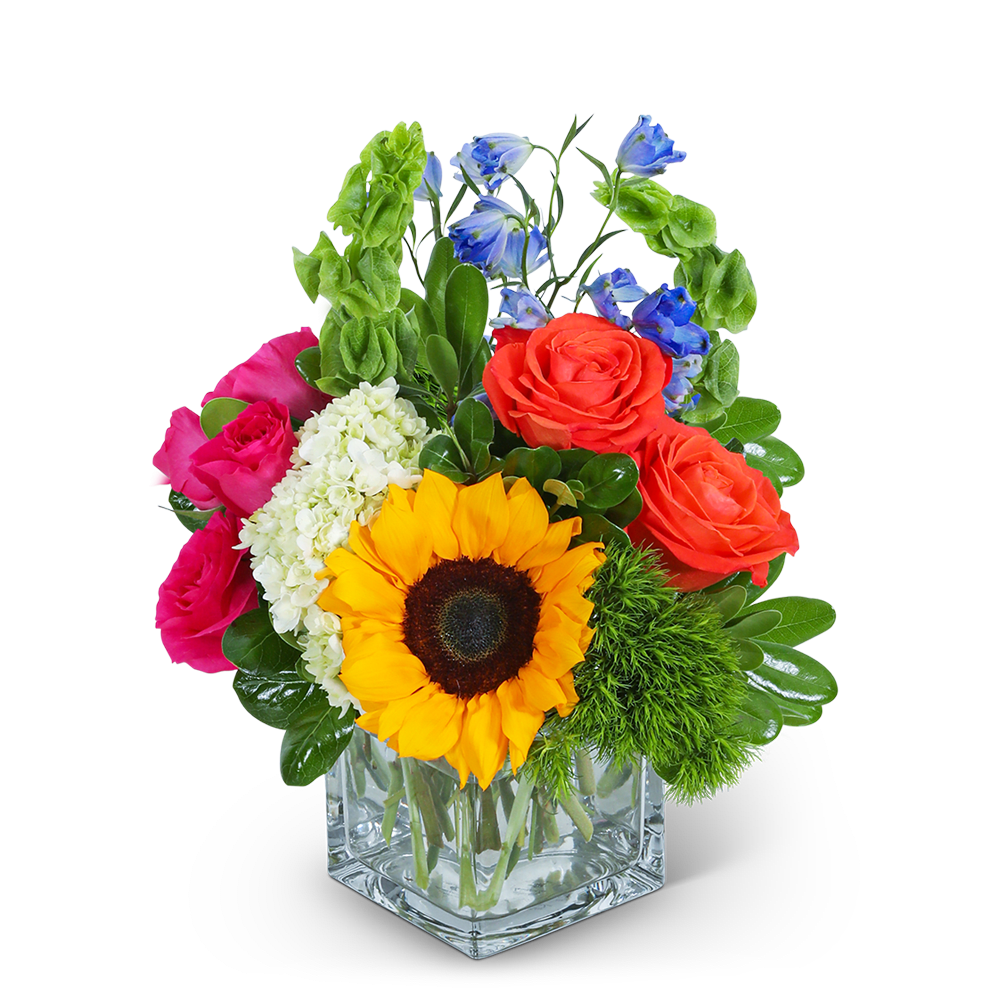 Colorful bouquet with roses, sunflower, and blue flowers in a clear glass vase