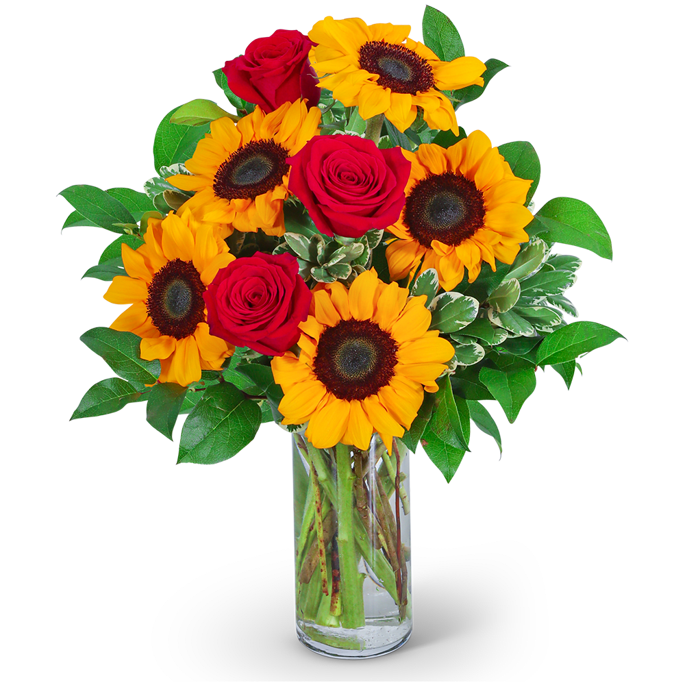 Bouquet of red roses and yellow sunflowers in a clear glass vase
