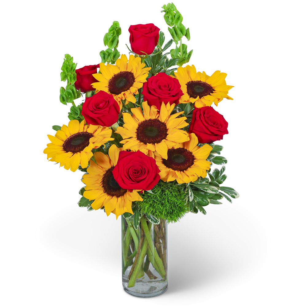 Bouquet of red roses and yellow sunflowers in a clear glass vase