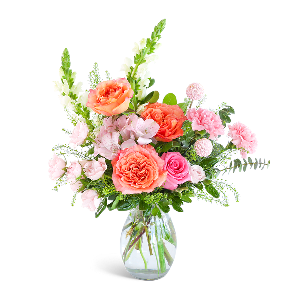 Pink and coral flower arrangement in a clear glass vase