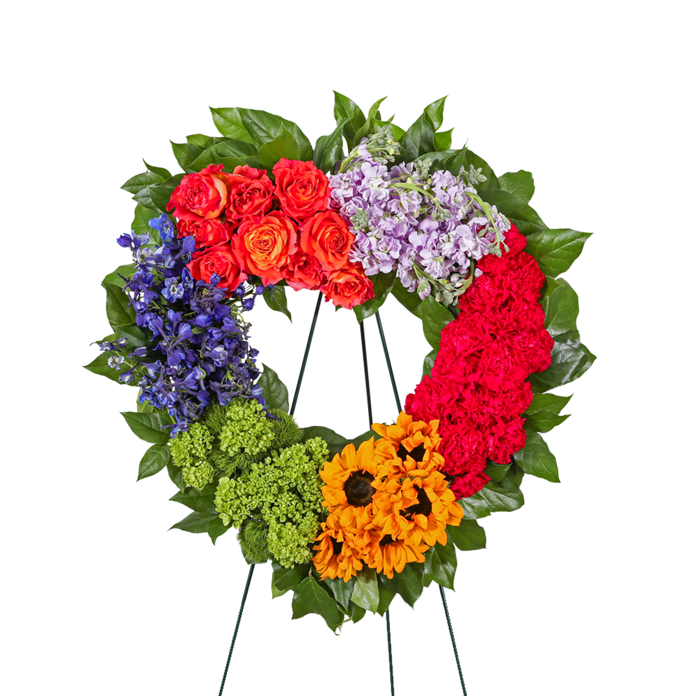 Colorful floral wreath on a stand with roses, hydrangea, and sunflowers