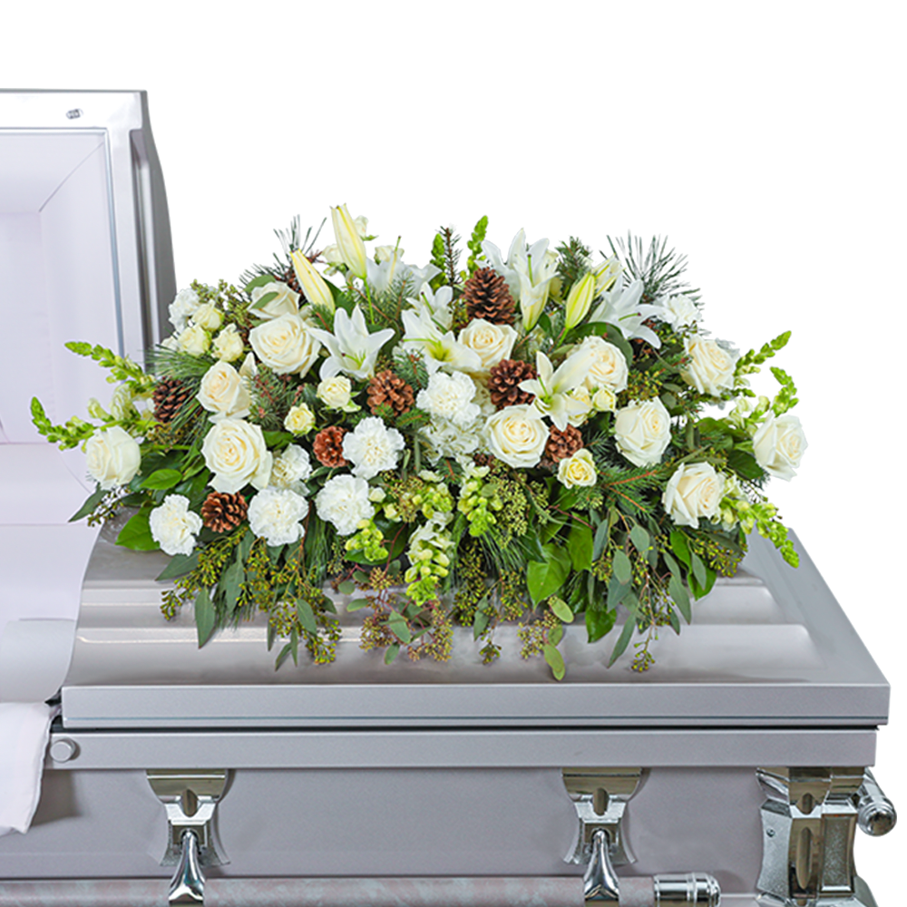 Unforgettable Casket Spray - Our Unforgettable Casket Spray is a beautiful arrangement featuring roses, carnations, hydrangeas, snapdragons, lilies, evergreen, and premium foliage with pinecone accents. The combination of white blooms and lush evergreen foliage creates a serene and elegant tribute. This heartfelt casket spray honors your loved one with a timeless and peaceful presence. The casket flowers are typically provided by the family of the deceased as a heartfelt memorial from the family and are designed to sit on the lid of the casket for a funeral service or memorial.