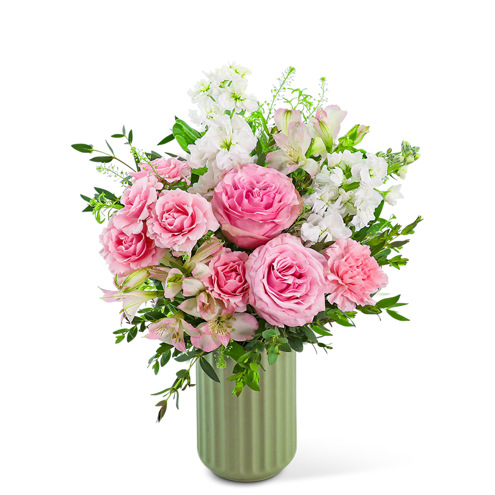 Pink roses and white flowers arranged in a green vase