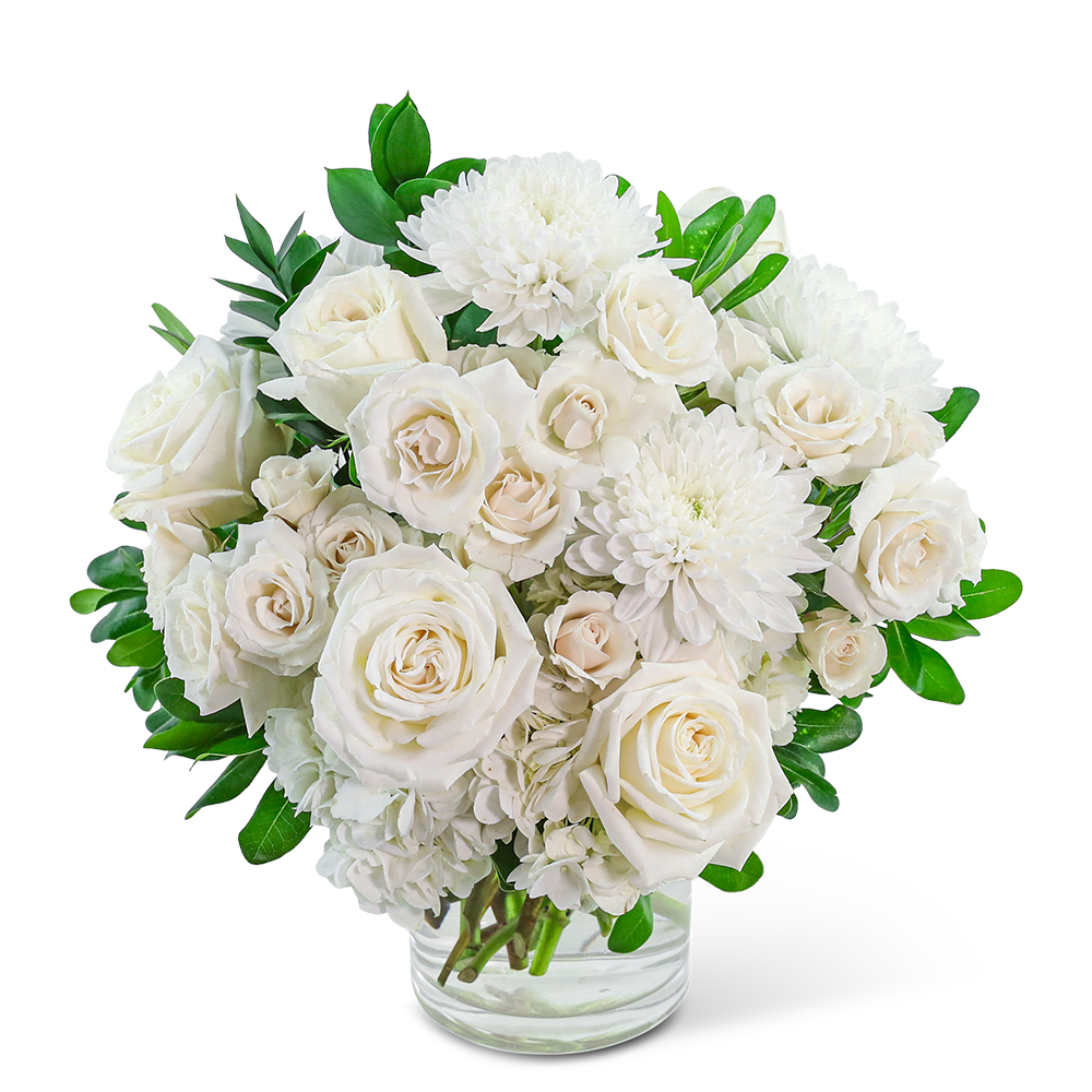 White roses and chrysanthemums in a clear glass vase