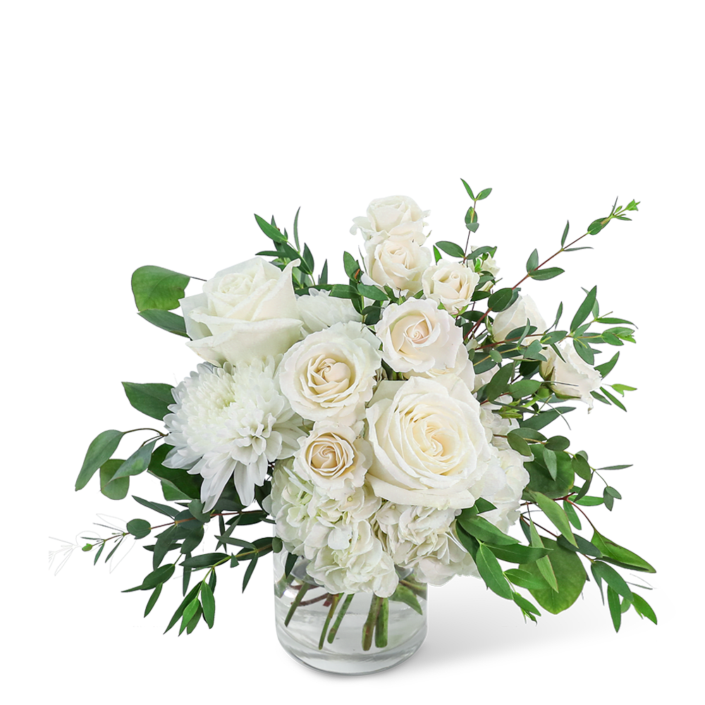 White roses and chrysanthemums in a clear glass vase