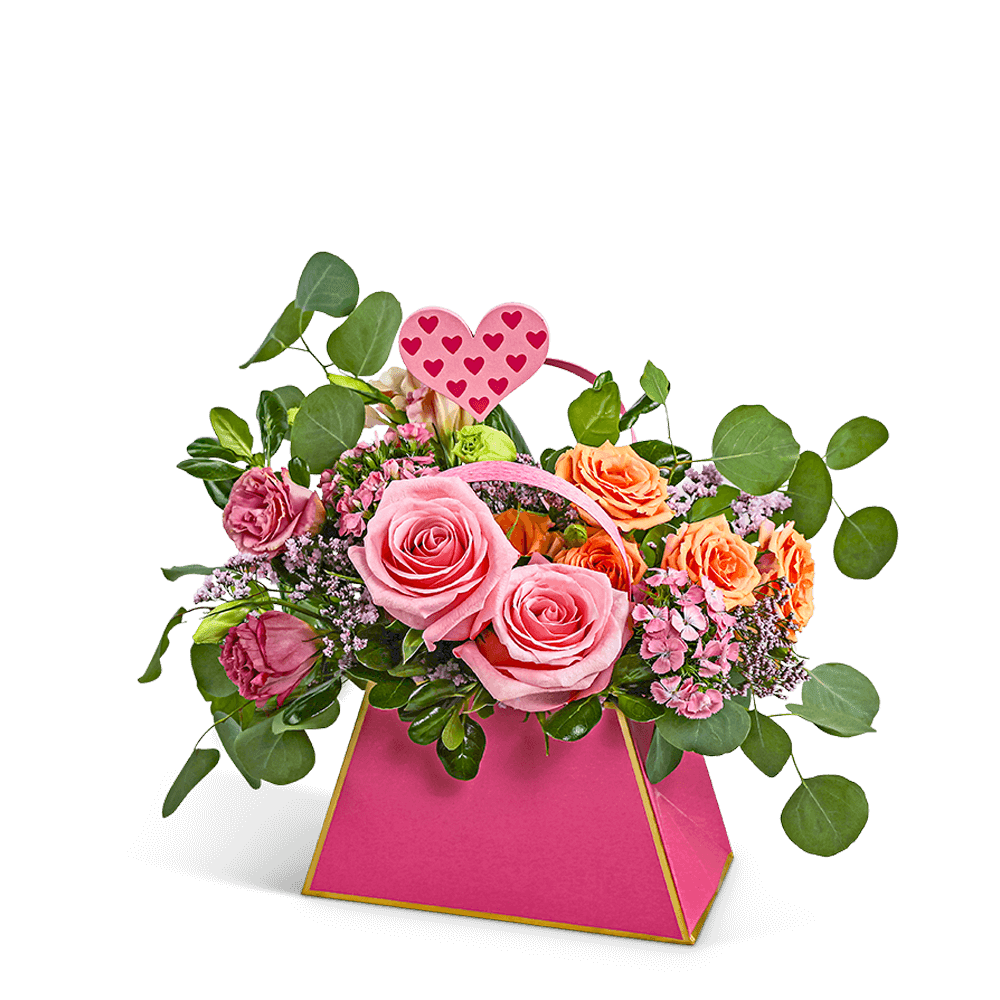 Pink and peach rose arrangement in a bright pink box with a heart pick