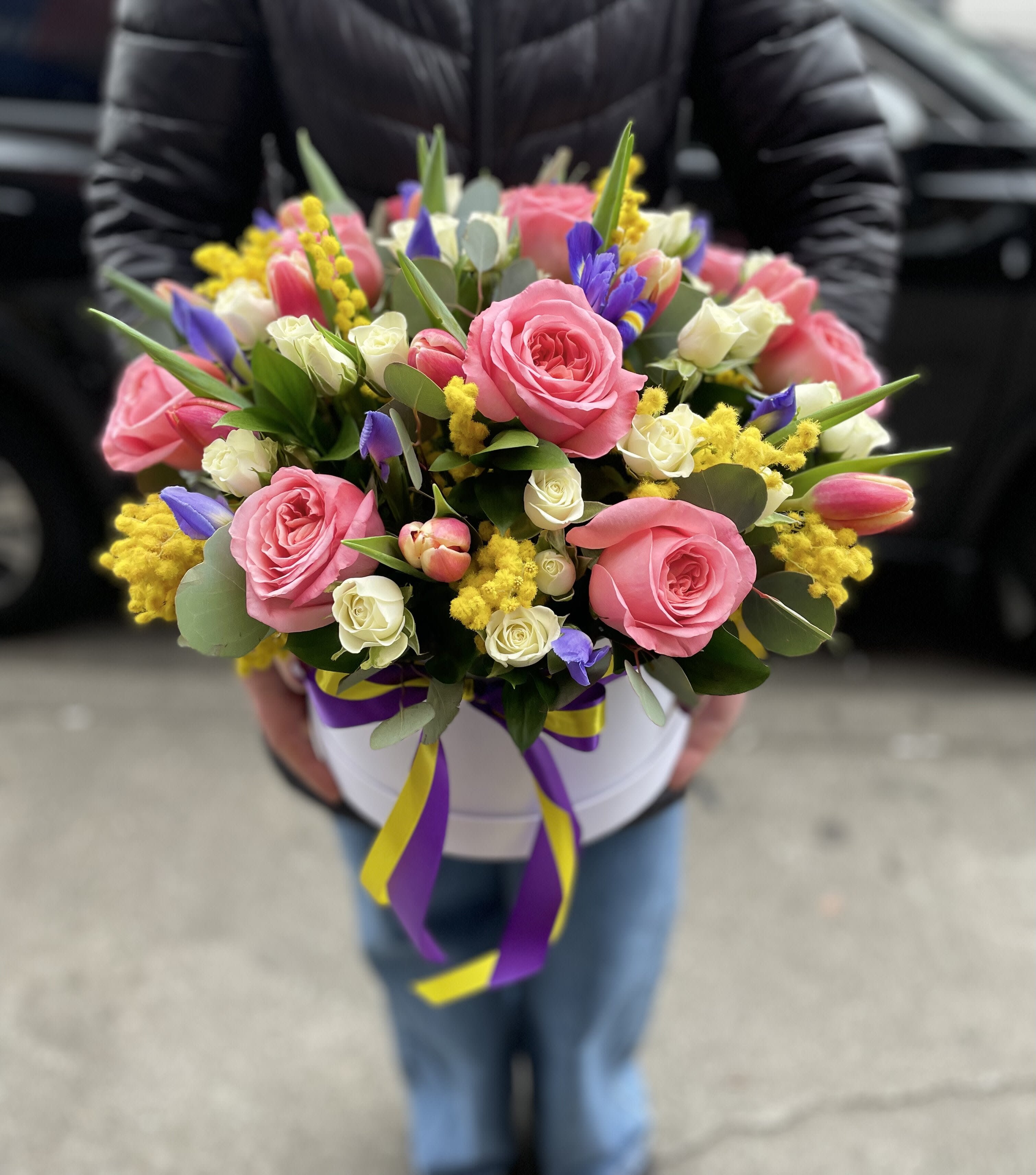 Pink and white rose bouquet with purple accents in a white hat box