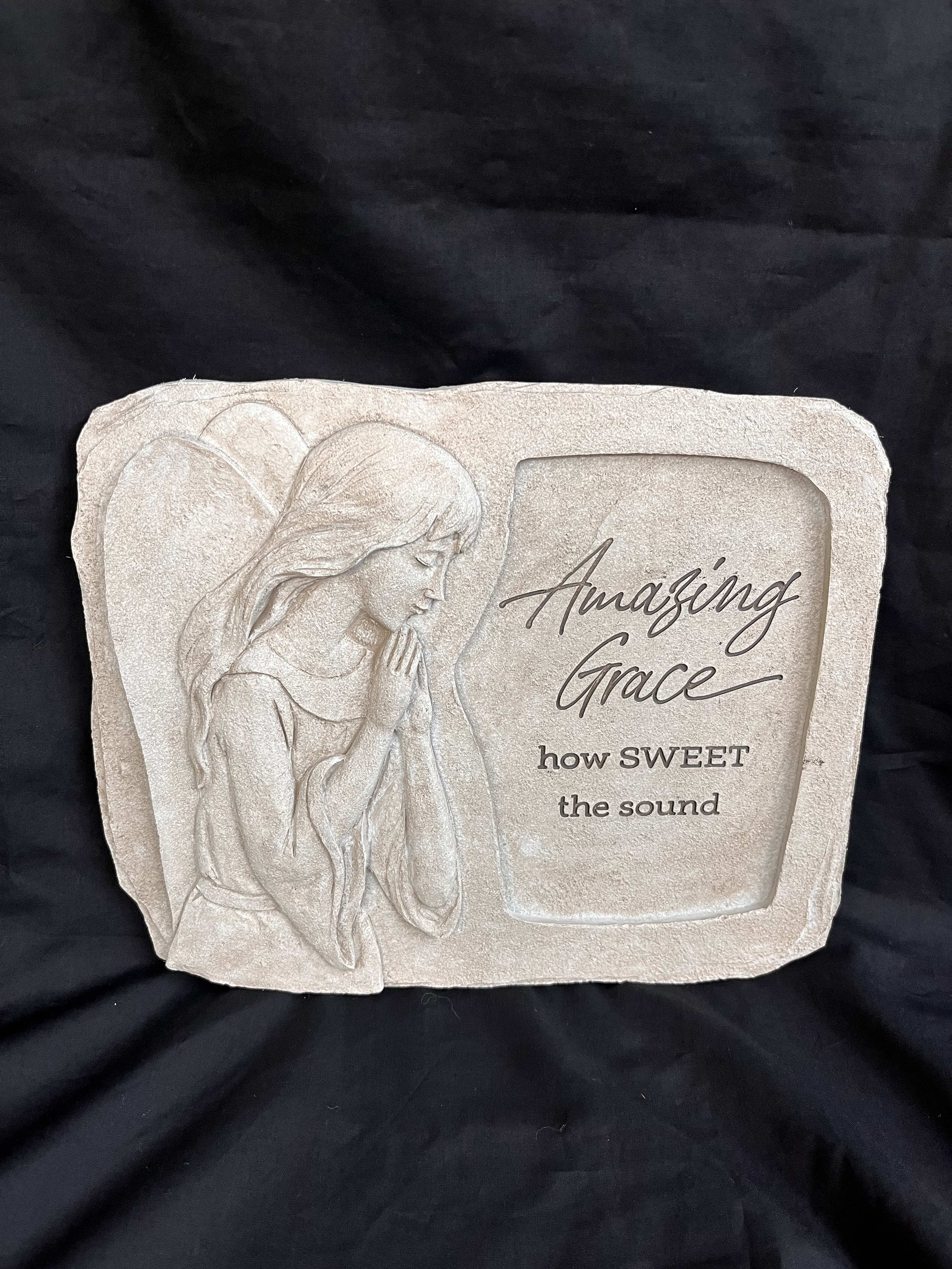 Beige memorial plaque with an angel relief and the words "Amazing Grace"