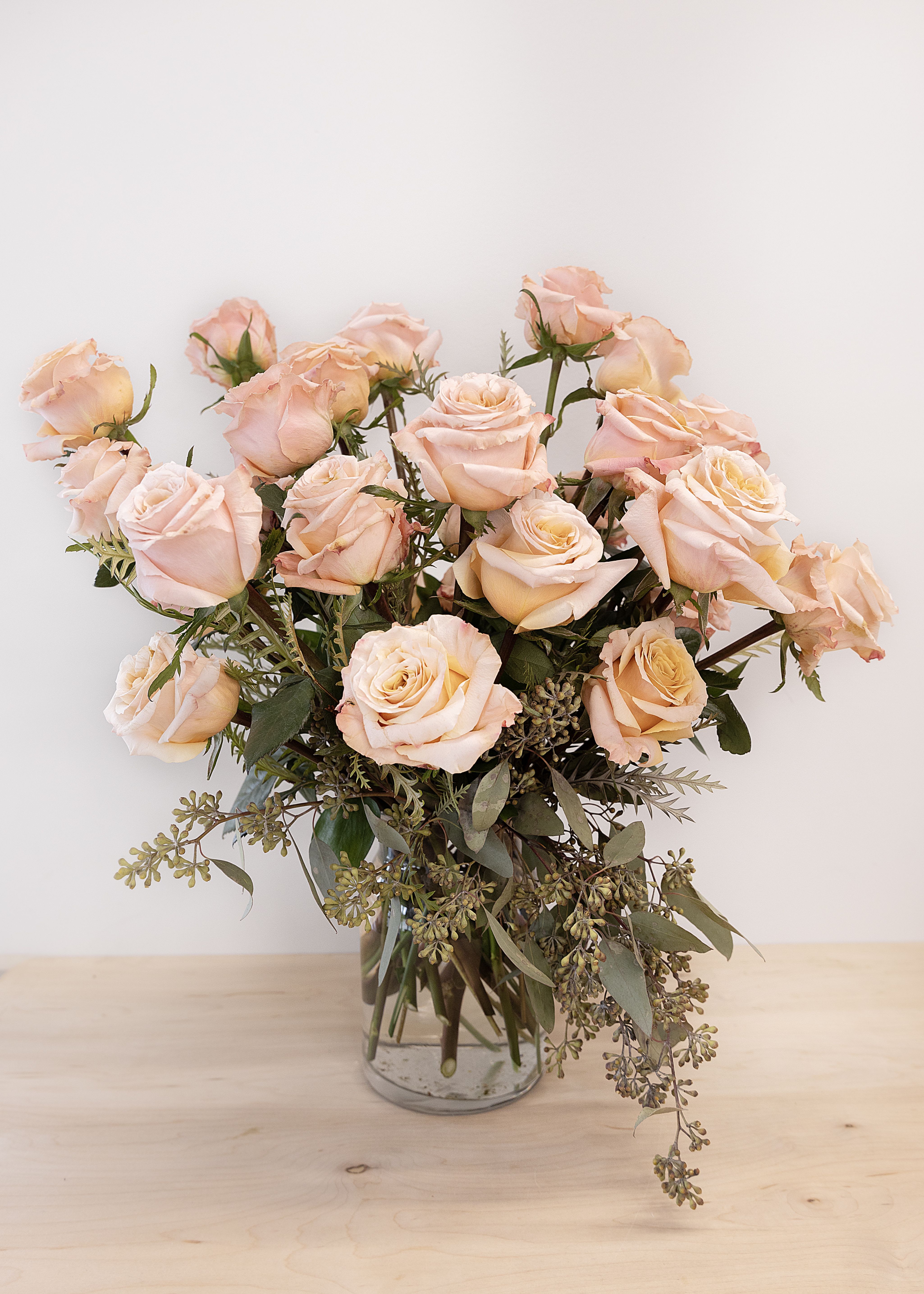 Blush peach rose bouquet in a clear glass vase