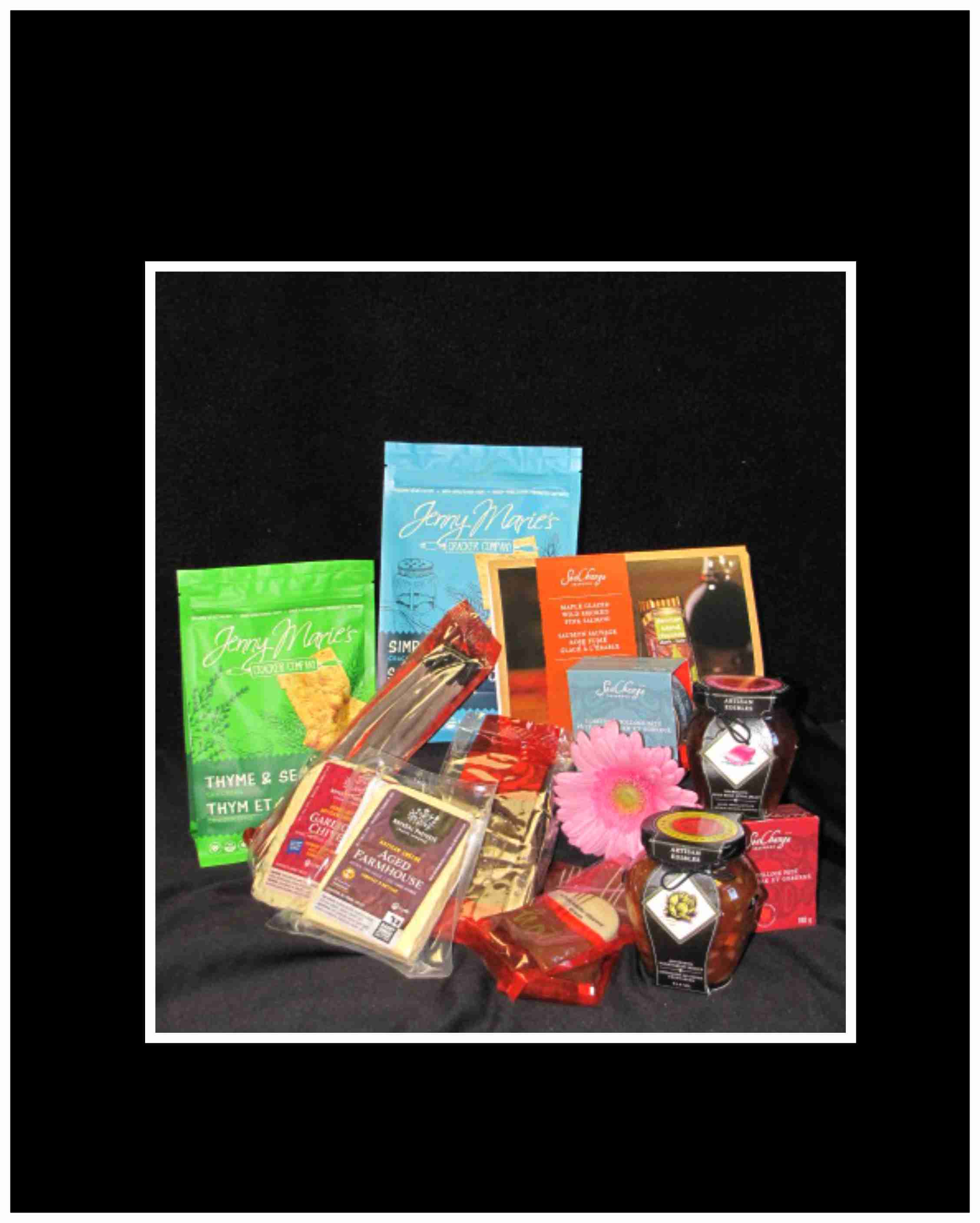 Assorted packaged food gifts with a pink daisy accent