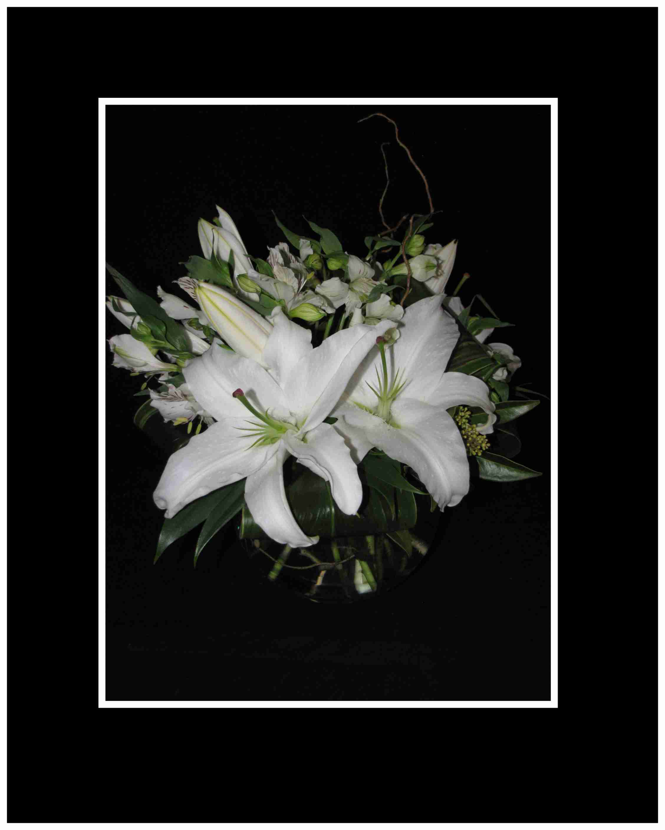 White lily bouquet in a clear vase