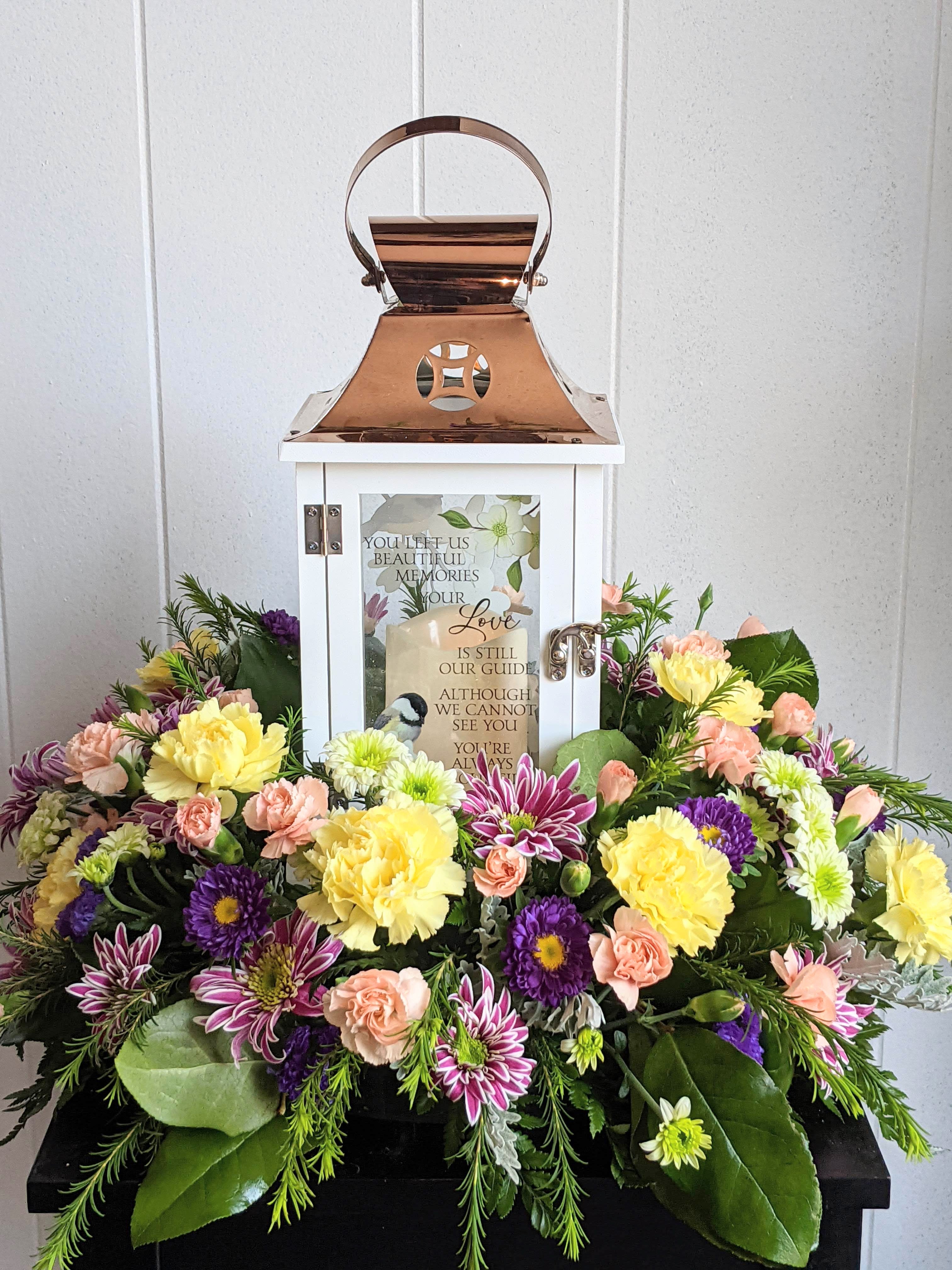 Sympathy lantern surrounded by pastel flowers